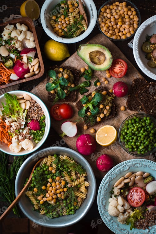 Preview: Different salad and appetizer on the wooden table top view