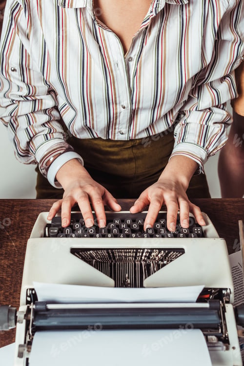Preview: cropped image of retro styled african american journalist typing at typewriter