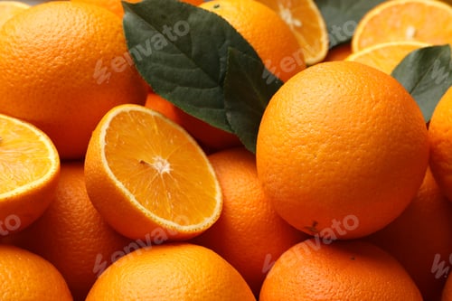 Preview: Juicy oranges and green leaves as background, closeup