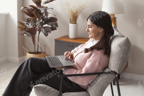 Preview: Portrait of young female freelancer working on a computer at home. Businesswoman studying online