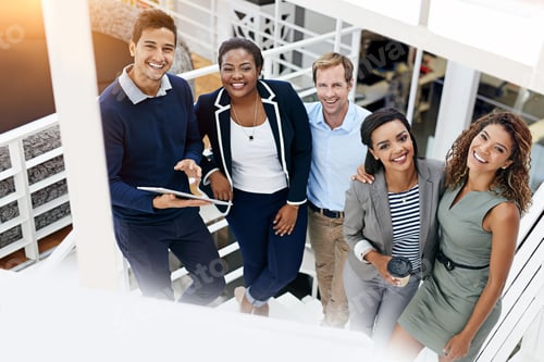 Preview: Portrait of a group of coworkers having a meeting in a stairwell in a modern office