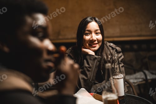 Preview: Friends enjoying a casual evening conversation at a cozy café in the city during late hours