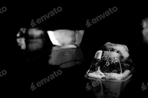 Preview: Ice cube on black mirror surface. Space for text