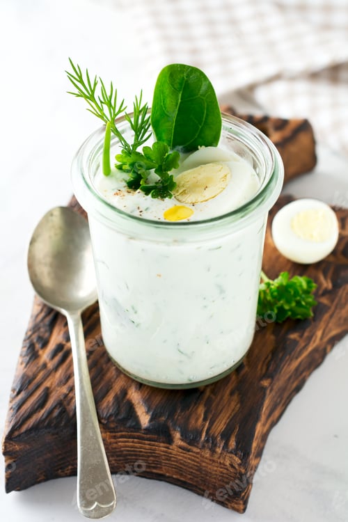 Preview: Glass of healthy yogurt with a variety of herbs, spinach, dill, onions, parsley and quail eggs. The
