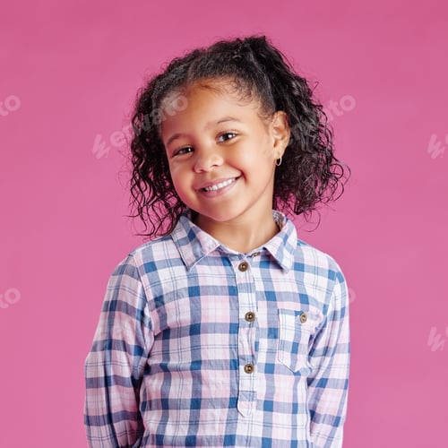 Preview: A portrait of a pretty little mixed race girl with curly hair posing against a pink copyspace backg