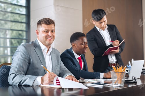 Preview: Business meeting with professionals discussing strategies in a modern office setting