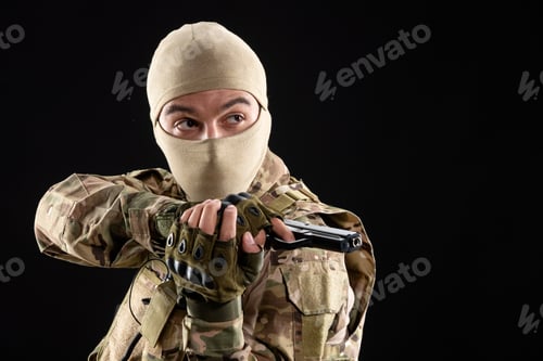 Preview: front view of young soldier in uniform aiming gun on black background warrior tank israel