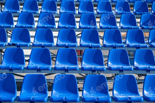 Preview: Stadium seats background. Rows of blue plastic empty chairs