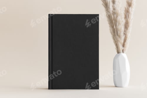 Preview: Black book mockup with a pampas decoration on the soft yellow background.