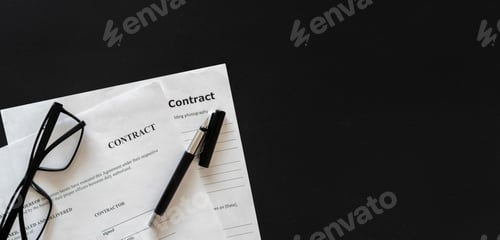 Preview: a close up macro view of a contract document with eye glasses and a pen