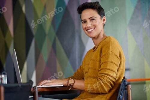 Preview: Portrait of a confident young businesswoman sitting in an office
