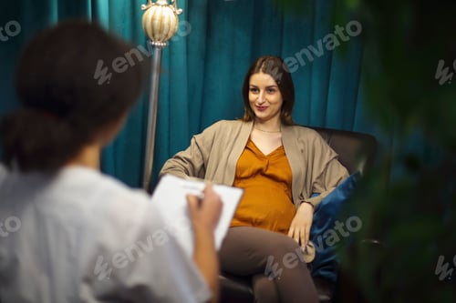 Preview: Happy young Caucasian pregnant woman talk consult with gynecologist in private clinic or hospital