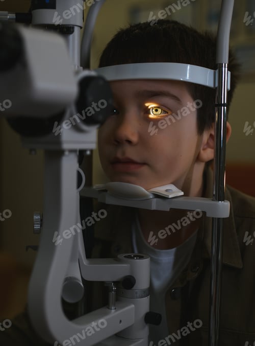 Preview: Boy undergoing eyesight examination with slit lamp biomicroscope in ophthalmology clinic