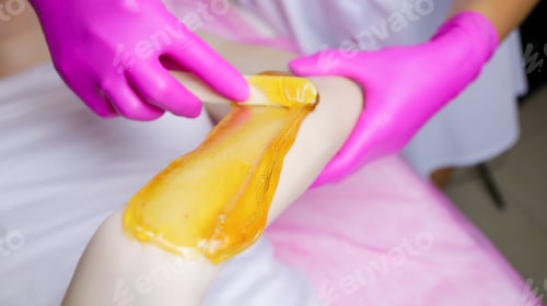 Preview: close-up of the application of sugar paste on the model's hand, the master applies the paste