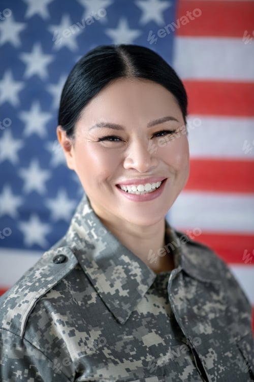Preview: Beaming servicewoman laughing while coming back home