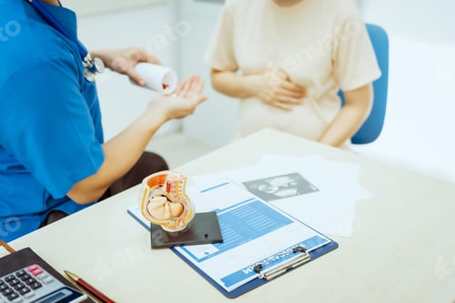 Preview: A male Asian pediatrician in a white lab coat prenatal checkup for a middle-aged pregnant woman