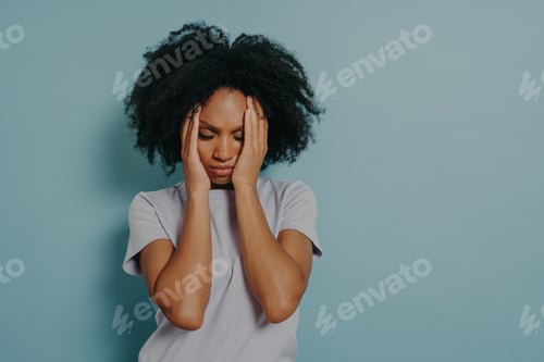 Preview: Tired stressed young african woman sighing from tiredness or suffering from headache