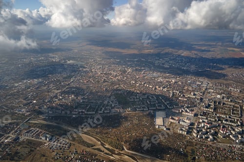 Preview: Aerial view from airplane window at high altitude of distant city