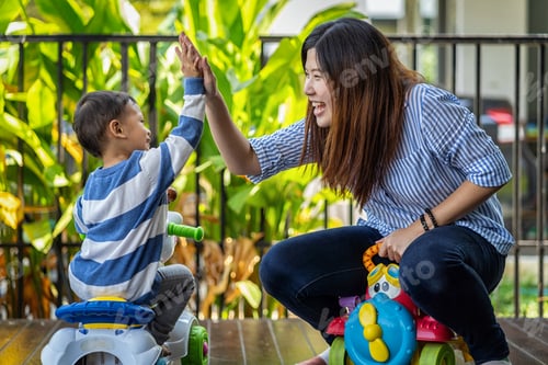 Preview: Asian single mom with son are playing with car toy and give me five together when living