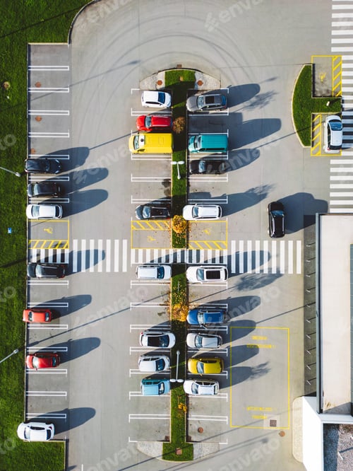 Preview: Vertical photo directly above a parking lot, colorful cars parked on it
