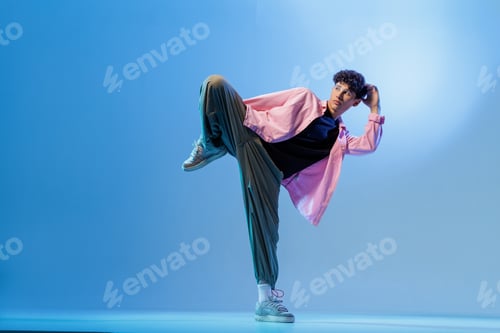 Preview: Bboy freeze in neon blue studio with copy space