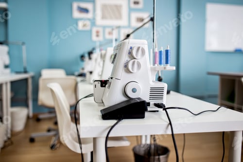 Preview: A white electric sewing machine is standing on the white table in the tailor's room