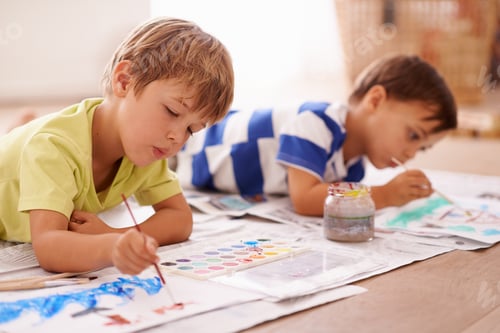 Preview: Unleashing their inner artists. Shot of two young boys painting pictures at home.