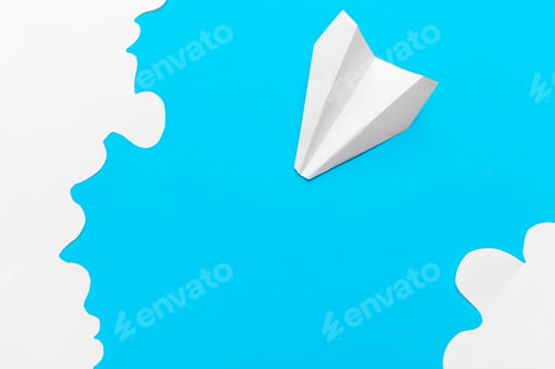 Preview: Flying paper plane in the clouds on a blue background. Concept of flight, travel, transfer