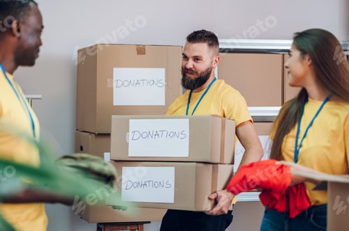 Preview: Group of multiracial volunteers working in community charity donation center
