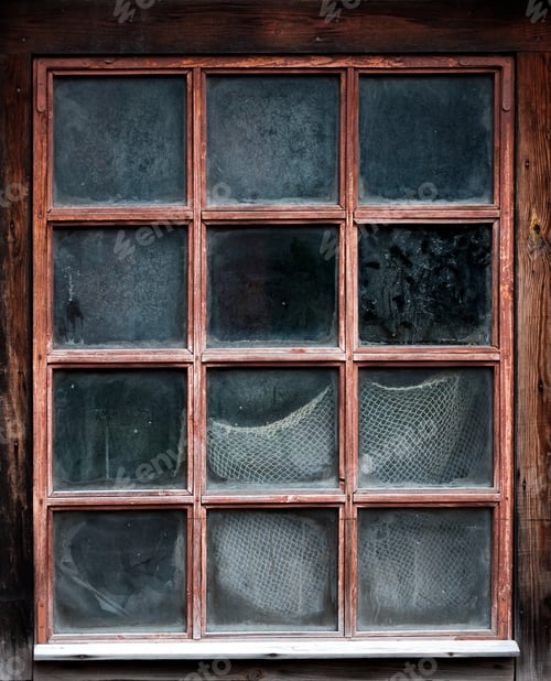 Preview: The window of an old,wooden farm house with net