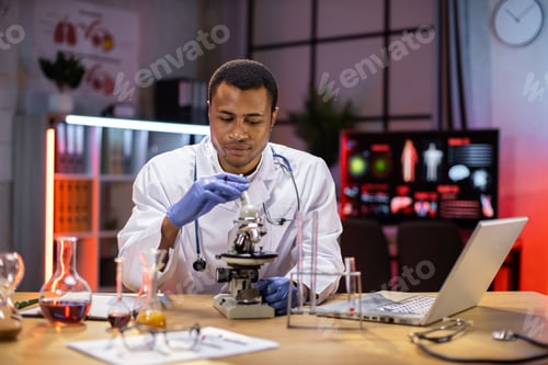 Preview: Young african american male researcher looking at the microscope
