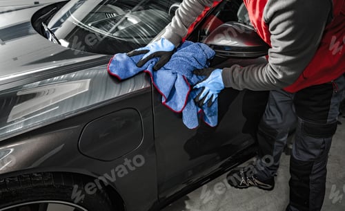 Preview: Car Wash Worker Removing Water From a Car Body