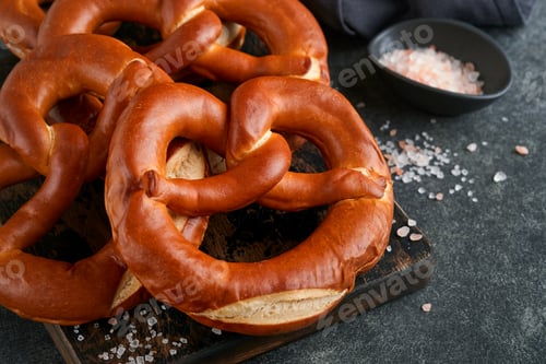 Preview: Oktoberfest concept card. Traditional Bavarian pretzels with beer bottle mug on old dark black rusti