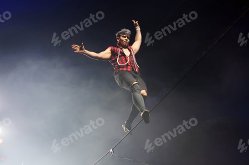 Preview: Agile man balancing on a tightrope during performance