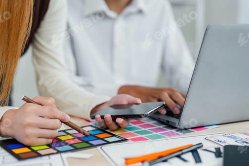 Preview: UI designer and UX developer brainstorm idea to design the application interface. Creative digital
