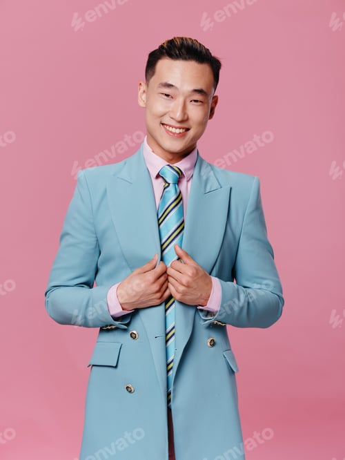 Preview: Man of Asian appearance blue jacket pink background self-confidence