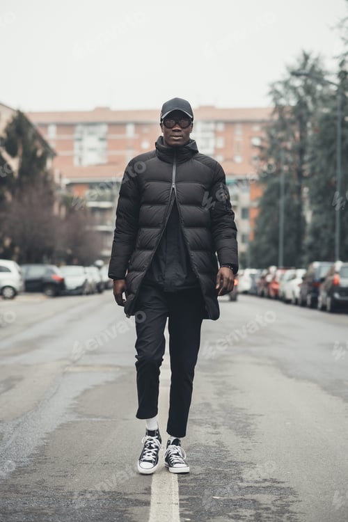 Preview: young black man running in the street and looking camera