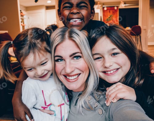 Preview: Woman and Children Smiling Together Indoors