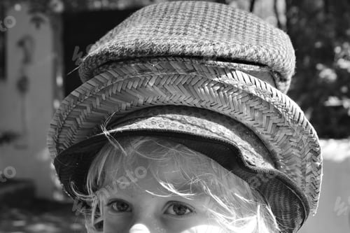 Preview: Boy wearing a stack of hats