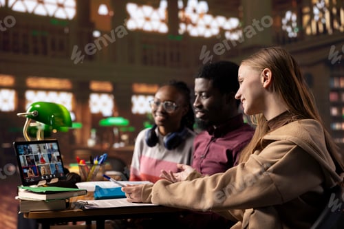 Preview: Diverse group of pupils attending online class webinar from the campus library