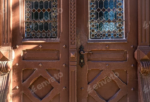 Preview: Old brown vintage doors with stained glass windows.