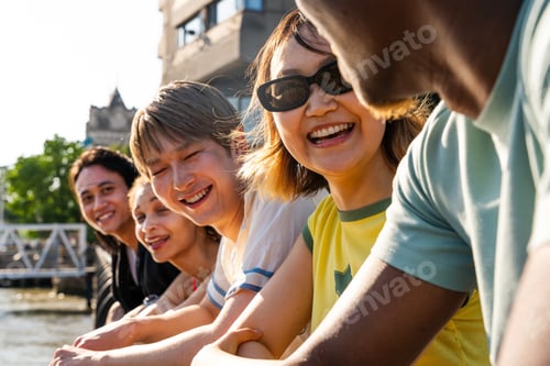 Preview: Multiracial group of happy young friends bonding in London