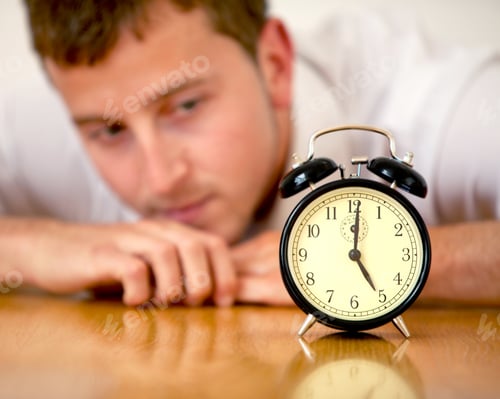 Preview: Business Man Looking At An Alarm Clock