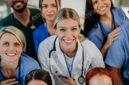 Preview: High angle view of happy doctors, nurses and other medical staff in hospital.