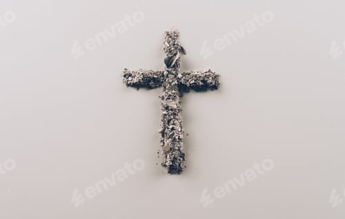 Preview: top view of cross shape from ash on white surface