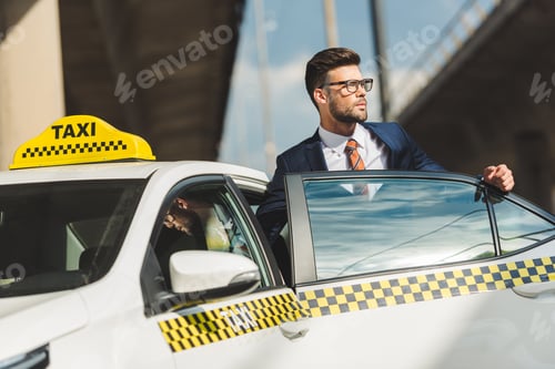 Preview: Man in Suit Getting into a Taxi