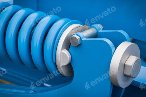 Preview: Blue hard spring made of steel. Part of big industrial or agricultural machine