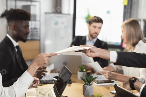 Preview: Multi ethnic business partners during office briefing