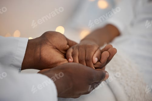 Preview: Shot of an unrecognizable doctor holding a patients hand at a hospital