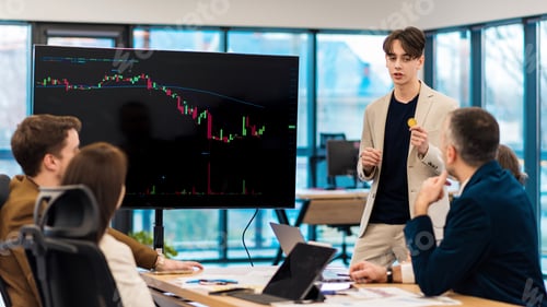 Preview: Young worker leading business meeting about cryptocurrencies in an office